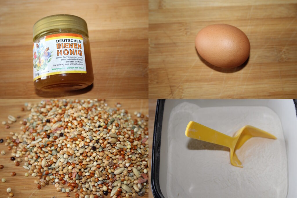 Das Foto zeigt die Zutaten für Knabberstangen: Ei, Mehl, Honig und Körnerfutter